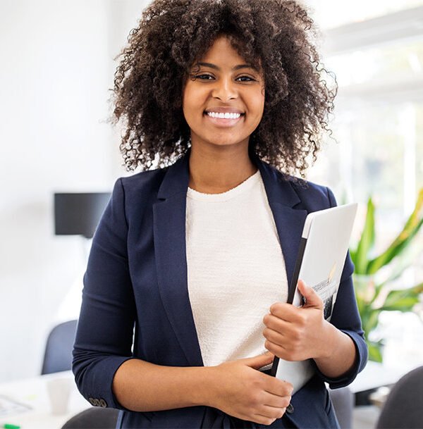 MSFT-A-confident-young-woman-standing-in-an-office-and-holding-a-clipboard
